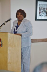A woman standing at the top of a podium.
