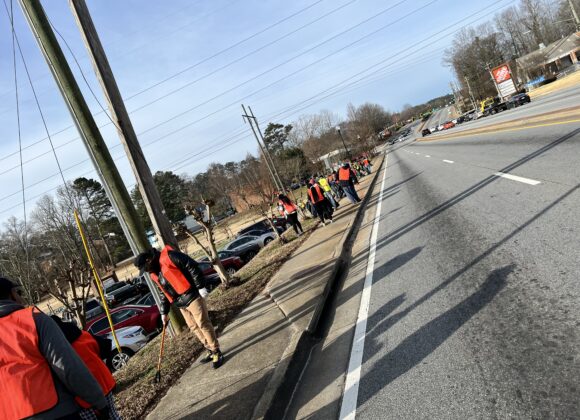 A group of people walking down the side walk