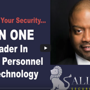 A man in black jacket and glasses next to a bull.