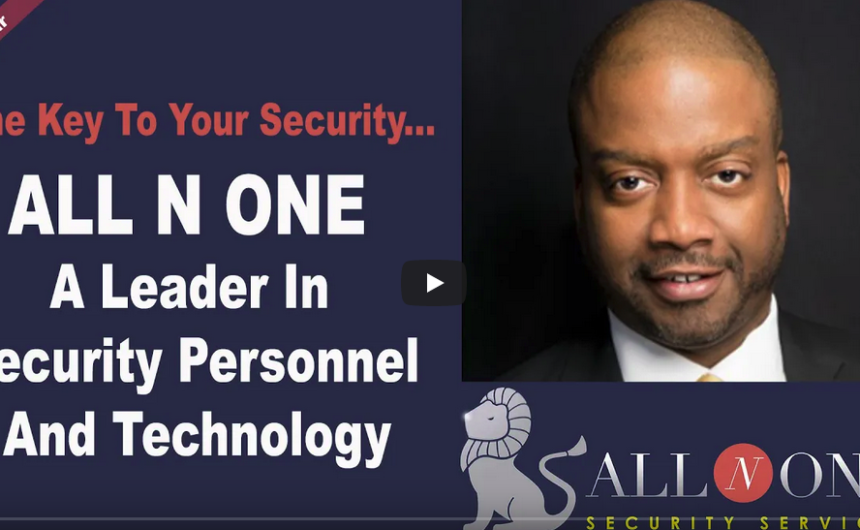 A man in black jacket and glasses next to a bull.